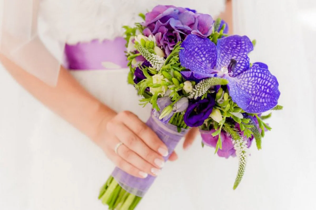 Bridal bouquet with purple orchids and freesias